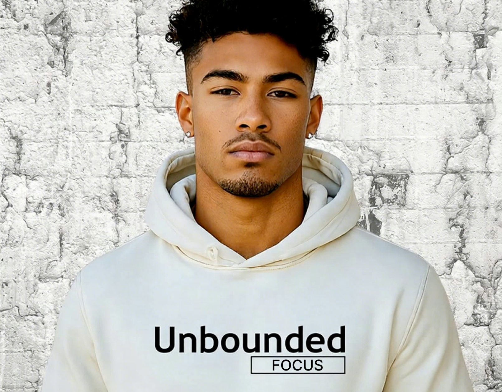 Person wearing a white hoodie with 'Unbounded Focus' text against a textured wall background